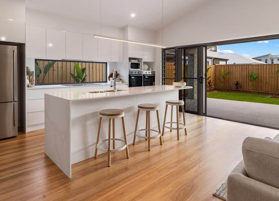 Warm kitchen with timber flooring and bifold doors